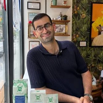 Subko’s founder smiling at the counter