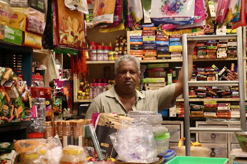 A shopkeeper behind his counter