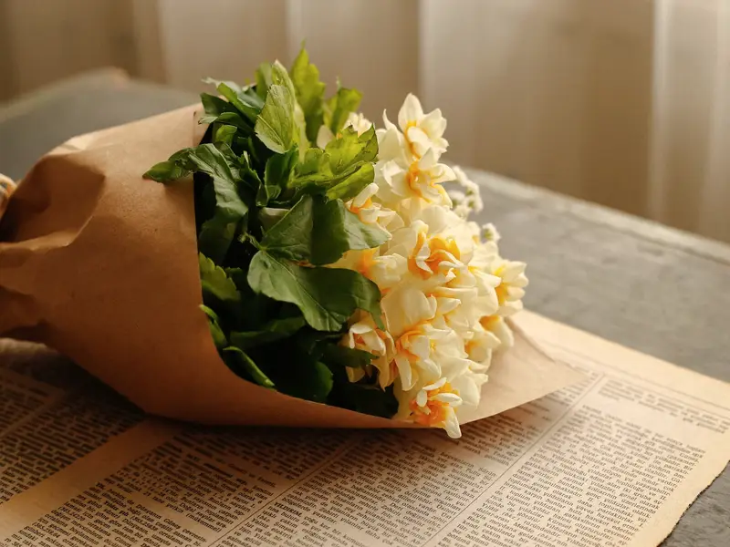 A bouquet of flowers wrapped in paper