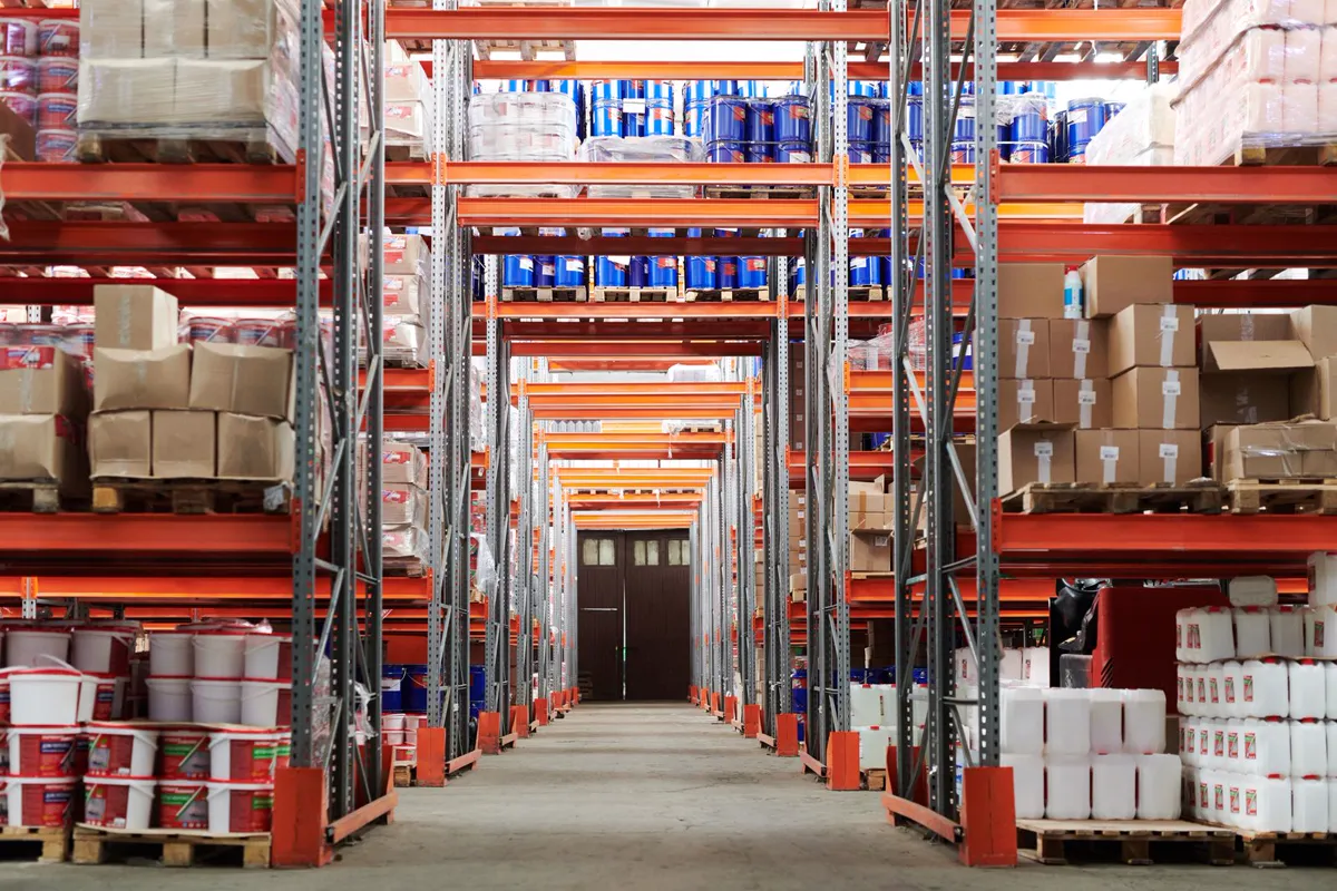 Aisles of tall racks stacked with boxes in a warehouse